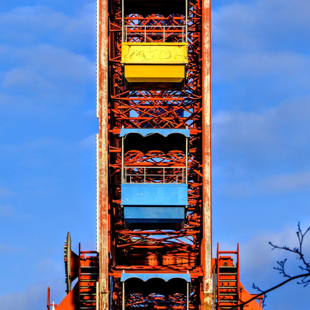 low-angle-view-ferris-wheel-against-blue-sky